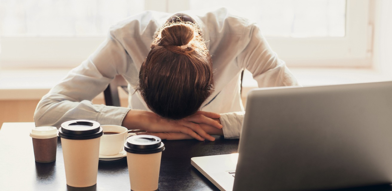 woman with head down on table
