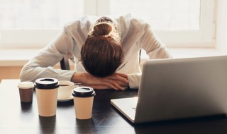 woman with head down on table