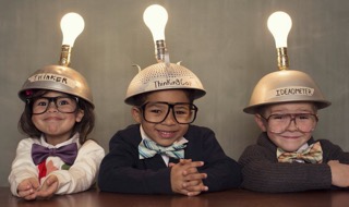 three children wearing hats with light bulbs